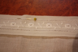 The insertion lace pinned down to sew.