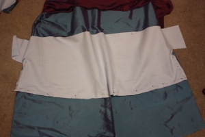 The front hem facing is pinned and cut to shape to match the skirt.