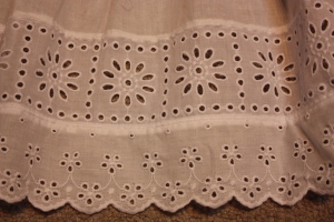 The bottom of the frill is edged with a row of insertion lace and a row of broider anglaise.